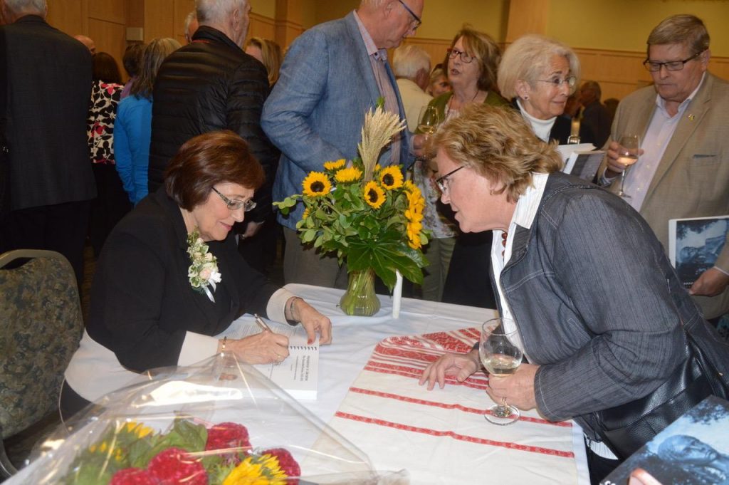 Valentina Kuryliw signing a copy of her book for educator Marta Dubyk. Photo: Mykola Swarnyk.